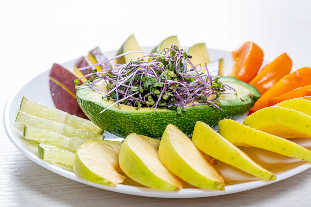 Frische Fahrt Von Joseph Von Eichendorff Frische Früchte geschnitten auf einem weißen Teller mit Avocado und